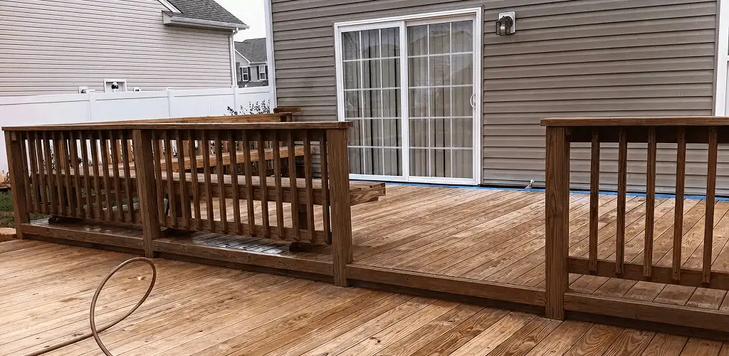 Deck sealing service protecting a backyard wood deck and railings in Mesa, AZ