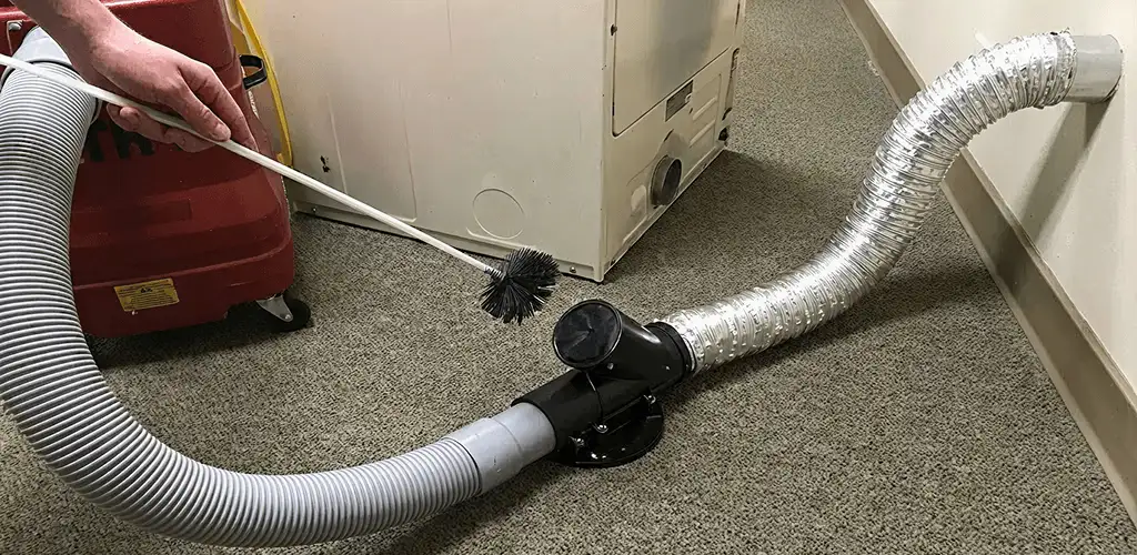 Dryer vent cleaning service removing lint from a dryer duct connection in Mesa, AZ