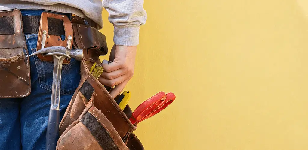 Handyman with tool belt ready for home repairs and maintenance in Mesa, AZ