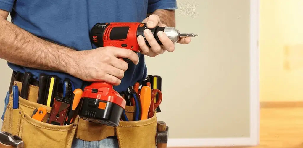 Handyman holding a power drill for home repairs and installations in Mesa, AZ