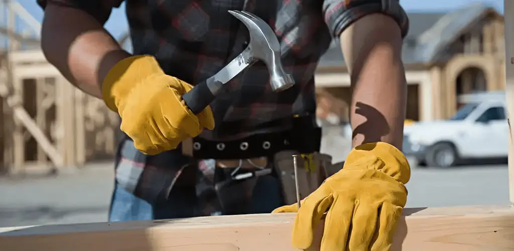 Handyman fixing wood trim with a hammer for home repairs in Mesa, AZ