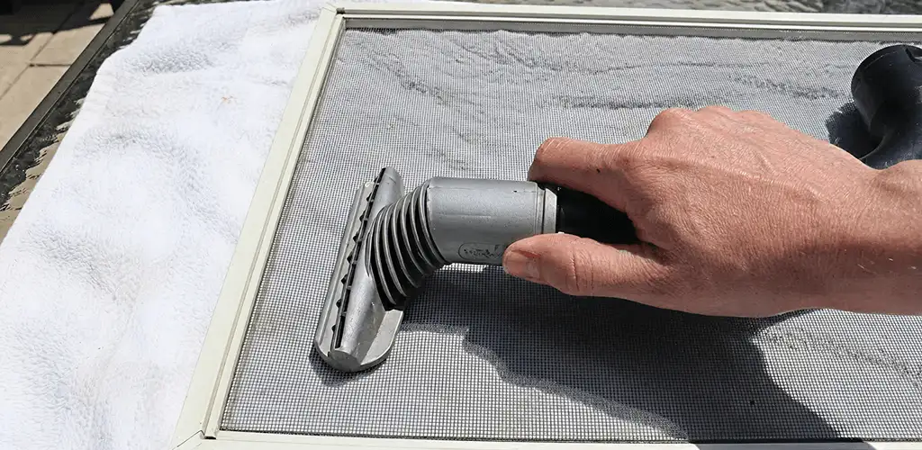 Window screen repair cleaning and fixing a damaged screen mesh in Mesa, AZ